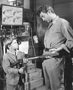 Robert Mitchum and Tommy Rettig.