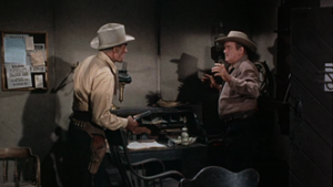 Buchanan (Randolph Scott) confronts corrupt Sheriff Lew Agry (Barry Kelley).