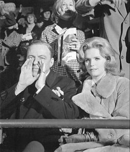 Joe (Frank Sinatra) and Karen (Lee Remick) watching a New York Giants v. Green Bay Packers game at Yankee Stadium. 