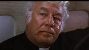 George Kennedy as Father O'Malley in The Delta Force (1986).