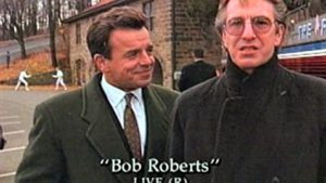 Ray Wise and Alan Rickman in Bob Roberts (1992). 