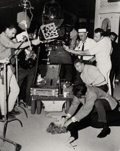 On the set of An American Dream: Eleanor Parker and Stuart Whitman (actors), Robert Gist (director, behind them) and Sam Leavitt (cinematographer, in white hat).