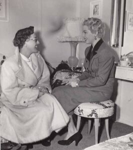 Joan Crawford pays a visit to Lana Turner on the set of A LIFE OF HER OWN (1950).