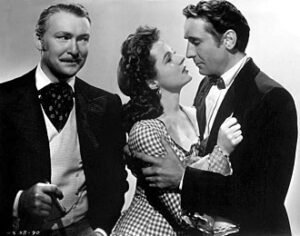 Albert Dekker, Jane Wyatt, and Victor Jory in The Kansan (1943).